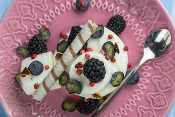 Ice cream with blueberries and blackberries with confectionery.