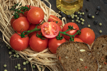 Fresh tomatoes from grapes on a wooden background. in a rustic style. season of vegetables. advertisement.Vegetables from the garden.