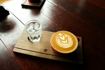 cafe latte art serve with ice water to fresh up the day 