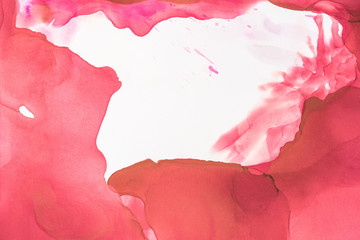 red splashes of alcohol ink on white as abstract background