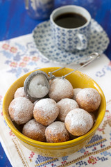 Vanilla krapfen doghnut with coffee. Rustic style.
