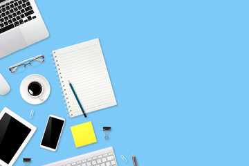 workspace table with laptop computer, office supplies, coffee cup, cell phone and coffee cup on blue pastel background