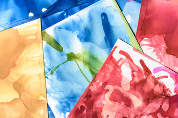 blue, red and green splashes of alcohol inks as abstract background