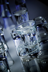A bunch of vodka glasses close up