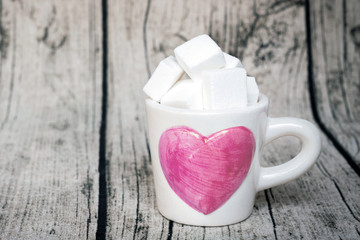 Full of love; sweet concept Valentine's Day with copy space on warm wood background