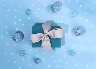 Blue gift boxe with Silver shiny Christmas bauble decoration.