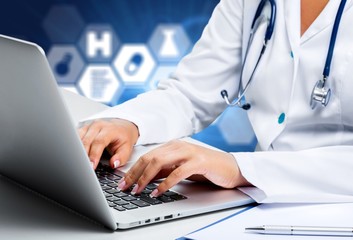 Close-up Doctor at hospital working with laptop