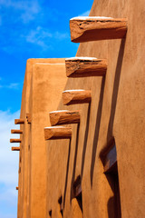 This is a simple architectural study under the warm sunlight and clear skies of Santa Fe New Mexico in early spring with light dusting of snow.