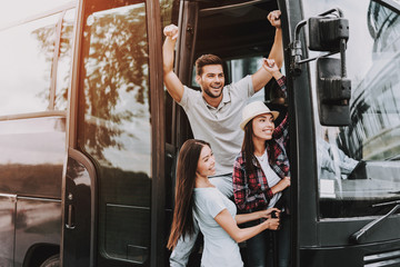 Young Smiling People Traveling on Tourist Bus