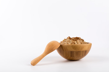 Porridge Cinnamon on top in a wooden bowl and wooden spoon isolated on white background, Copy Space.