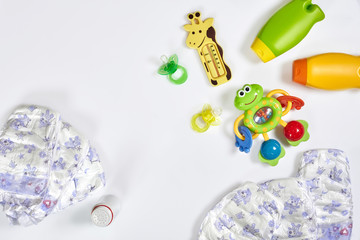 Set of accessories for baby. Pacifier, bottle, diaper, cream on white background.