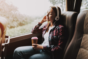 Smiling Woman Listening Music in Tourist Bus