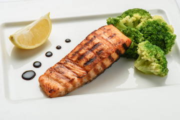 Baked fish salmon garnished with broccoli . Dietary menu. Fish menu. Seafood - salmon.