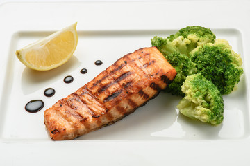 Baked fish salmon garnished with broccoli . Dietary menu. Fish menu. Seafood - salmon.