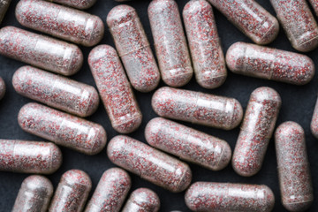 Transparent Drugs, Pills, Vitamins (Bilberry, Ginkgo, Lutein) Scattered On A Gray Slate Background. Medical Series. Close Up. Top View. Rustic Style.