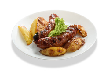 Fried sausages with a vegetable side dish and potatoes. Isolated on white