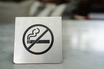 No smoking sign made of stainless on marble table