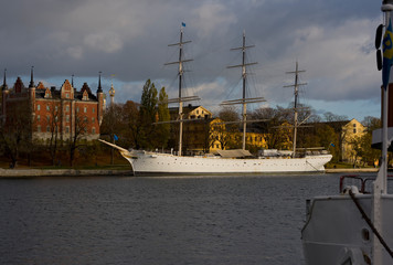 Water view over Stockholm an late autumn day, snowy, sun and clear sky over boats and landmarks