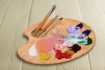 Wooden art palette with blobs of paint