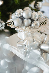 Christmas decor for table setting, or wedding decor, studio with a Christmas tree. Christmas decorations toys, candles, fir branches