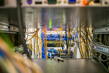The network equipment of the ISP is located in the data center. Many wires are stacked between...