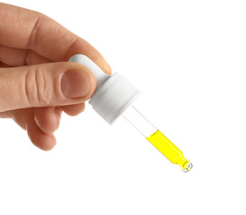 Woman holding pipette with oil on white background