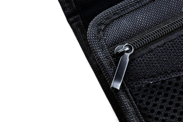 Close up of black leather bag zipper, black fabric bag close up