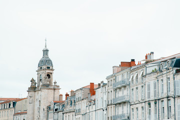 Fototapeta premium Beautiful old french buildings and bell tower in La Rochelle city