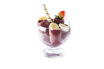 Ice cream cup with bananas and waffle on white background