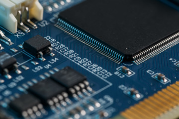 Electronic circuit board close up. Processor, chips and capacitors.