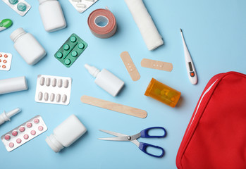 Flat lay composition with first aid kit on color background