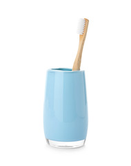 Bamboo toothbrush in holder on white background. Dental care