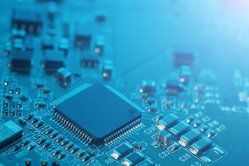 Electronic circuit board close up. Processor, chips and capacitors.