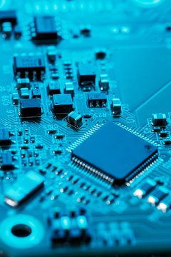 Electronic circuit board close up. Processor, chips and capacitors.