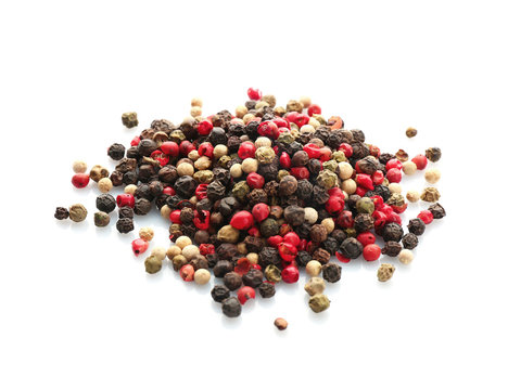 Mix of different pepper grains on white background