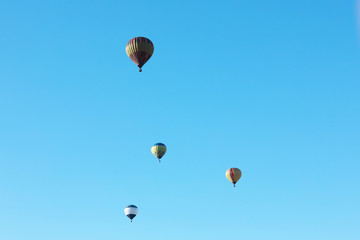 Colorful hot air balloons flying in blue sky