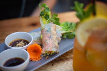 Vietnamese Summer Rolls on a plate against wooden background