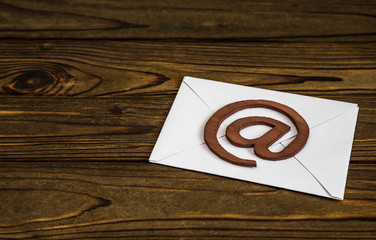 paper letter, email symbol on wooden background. Internet communication, interaction, information...