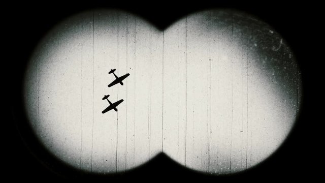World War II era military airplanes. Retro style. View through binoculars