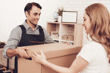 Courier in Blue Clothes Gives Woman Paper Box.
