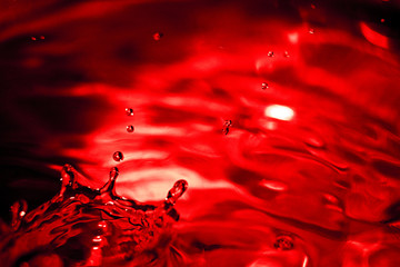 Bursts of red liquid is macro