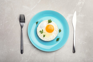 Fried sunny side up egg served on table, flat lay