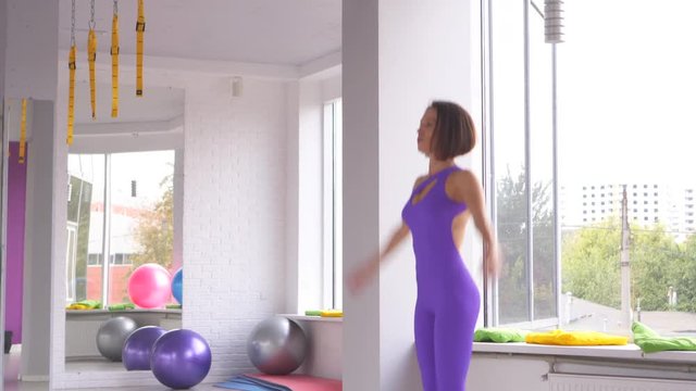 Woman Doing Jumping Jacks At Gym