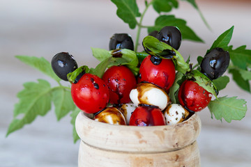 Tomato cherry and mozzarella skewers with modena vinegar