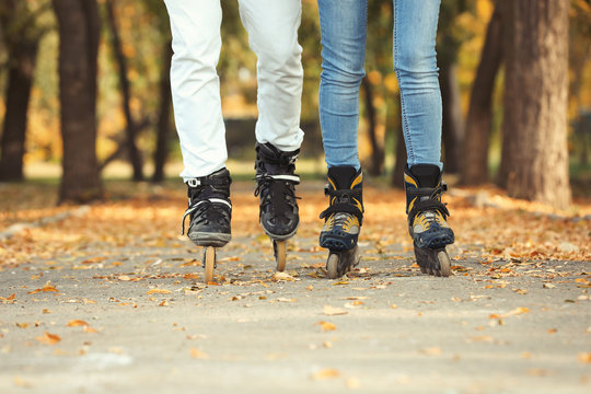 Couple roller skating in autumn park. Active leisure