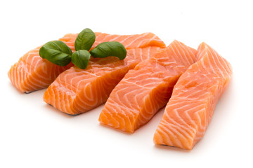 Fresh salmon fillet with basil on the white background.