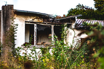 destroyed and broken building in nature
