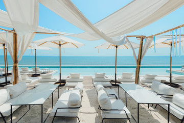 Fototapeta na wymiar Beautiful luxury swimming pool on sea view and umbrella and chair in hotel resort