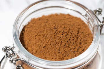 cocoa powder in a glass jar, closeup