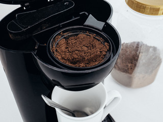 Spoonful of Coffee in Coffee Maker Machine Ready to Brew Coffee